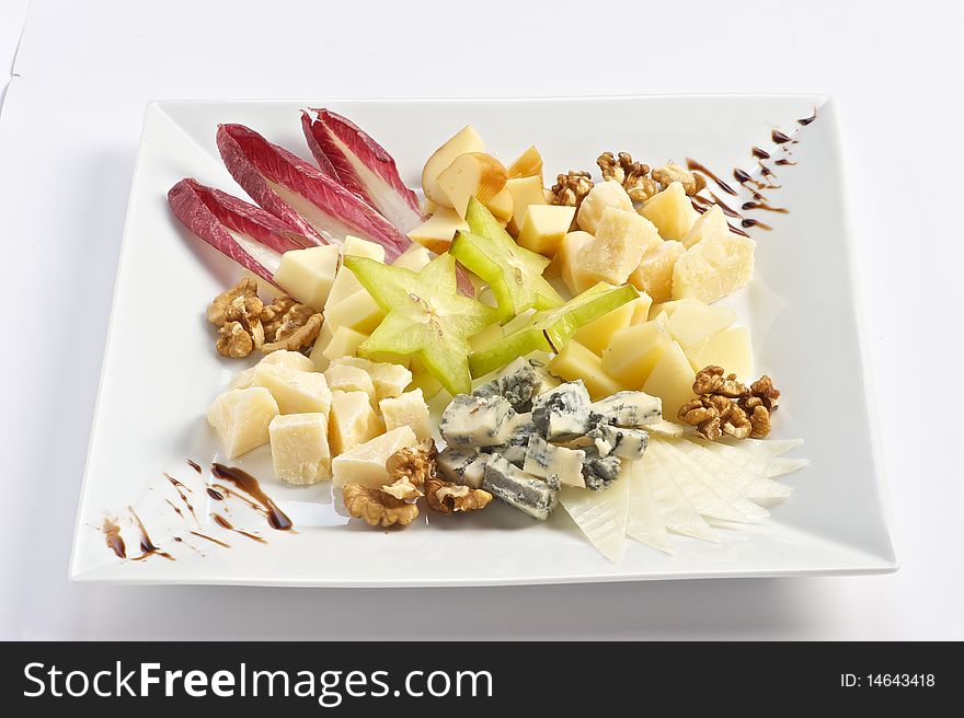 Heese plate of several kinds of cheese with honey walnuts and fruit. Heese plate of several kinds of cheese with honey walnuts and fruit