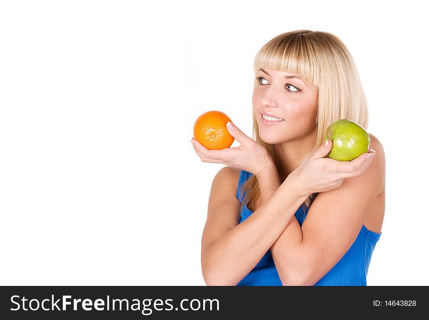 Beautiful girl chooses between orange and apple. Beautiful girl chooses between orange and apple