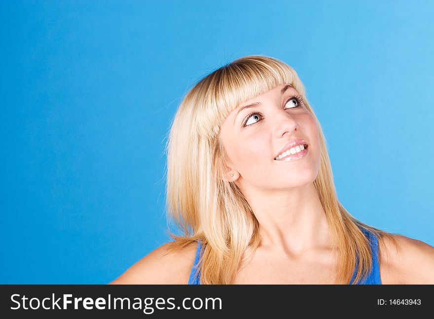 Portrait of happy young woman isolated on blue. Portrait of happy young woman isolated on blue