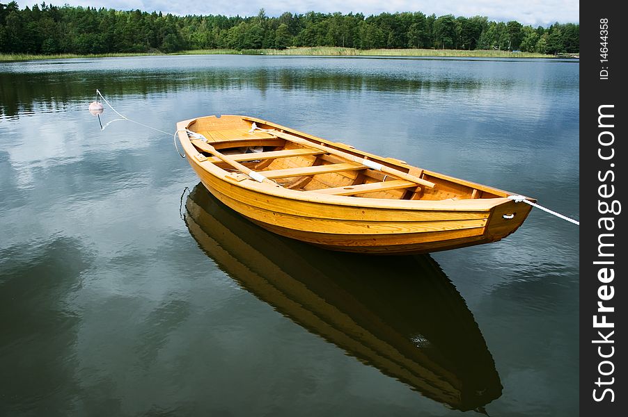 A typical swedish rowing boat, reflection in the water. A typical swedish rowing boat, reflection in the water.