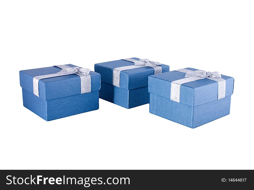 Three blue gift boxes with silver ribbons on it.