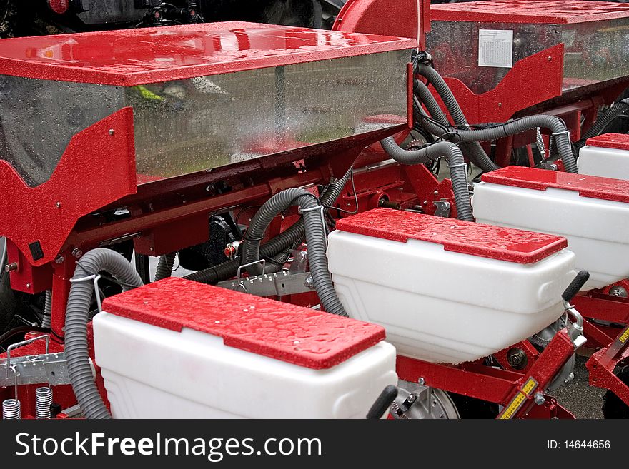 Close-up of farming tractor with equipment in red color. Close-up of farming tractor with equipment in red color.