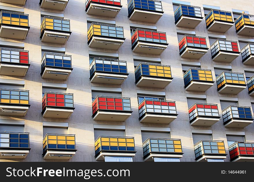 Multi-coloured balconies of a modern building in a city similar to a Cube Rubic. Multi-coloured balconies of a modern building in a city similar to a Cube Rubic