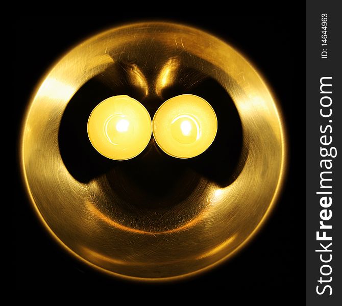 Photo of glowing smiley made of a bowl and two candles
