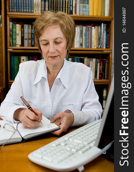 Elderly woman business-lady works at computer