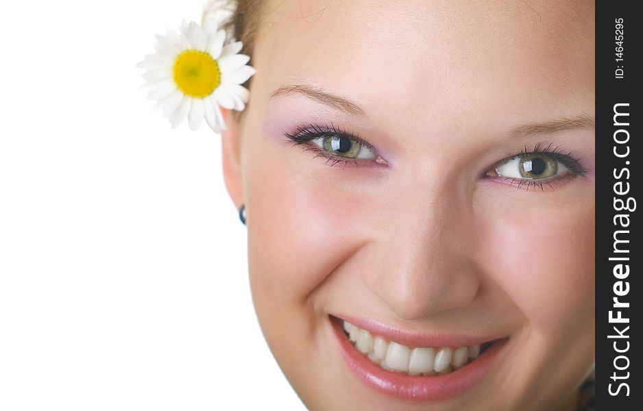 Beautiful young girl with chamomile on a white background