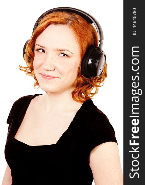 Redhead girl listening music in headphones