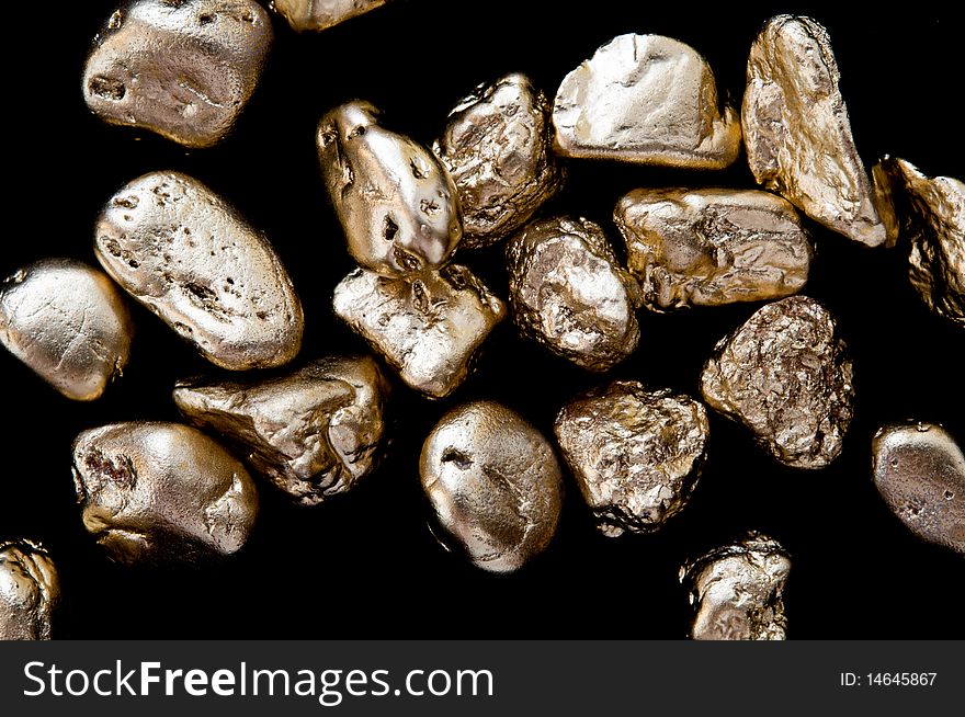 Gold nuggets on a black background. closeup.