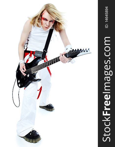 Rock musician is playing electrical guitar. Shot in a studio. Rock musician is playing electrical guitar. Shot in a studio.