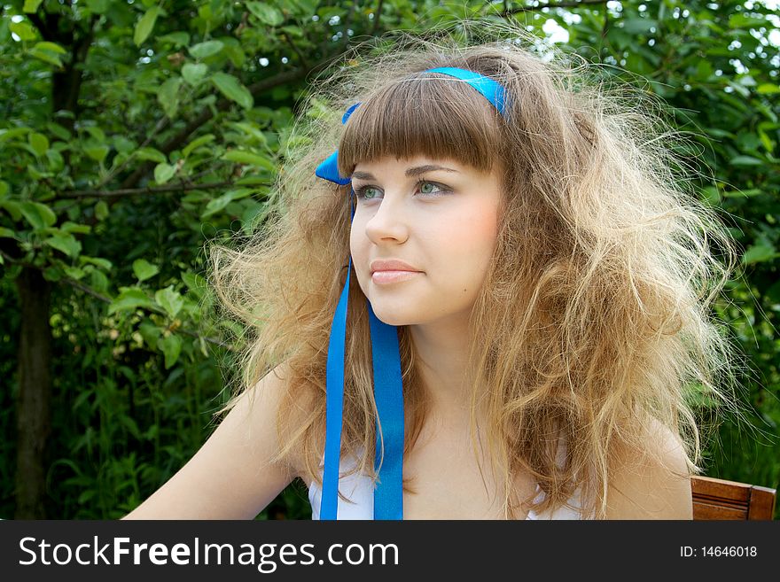 Beautiful girl with the crazy hair in the garden