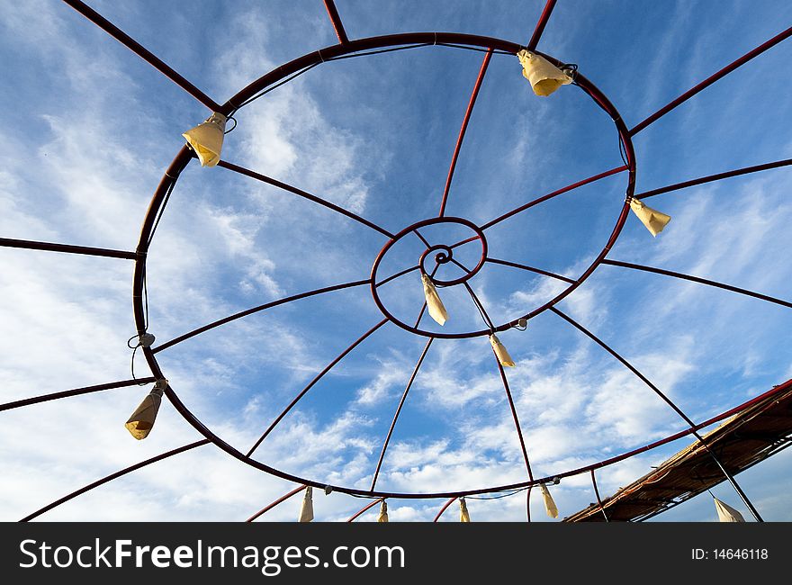 Spiral metallic frame against blue sky background. Spiral metallic frame against blue sky background