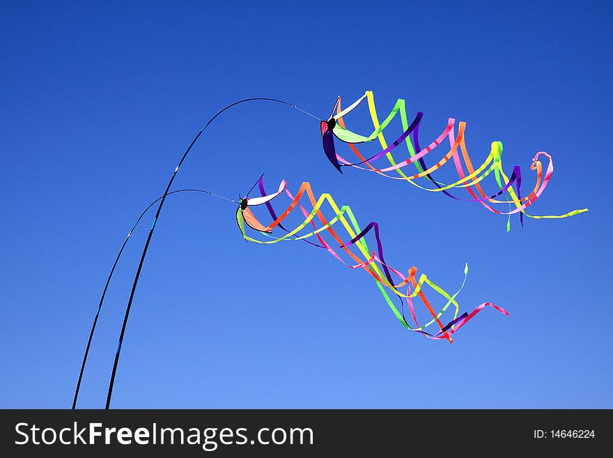 Two sets of coloured ribbons blowing in the wind