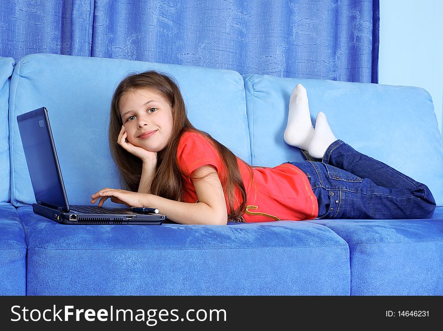 Girl with PC at home in sofa