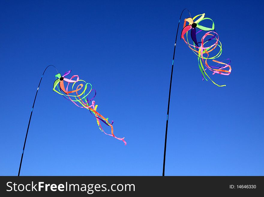 Two sets of coloured ribbons blowing in the wind. Two sets of coloured ribbons blowing in the wind
