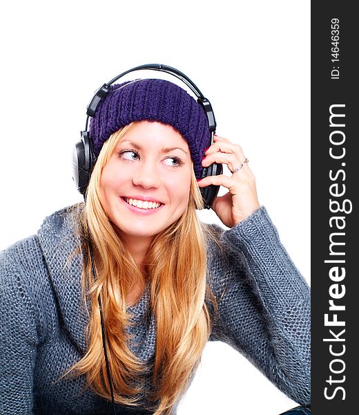 Smiling blond woman with headphones listening music over white