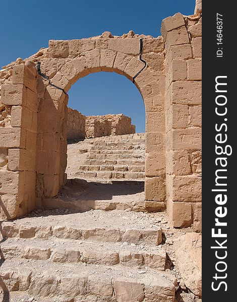 Ancient stone arch and staircase in bright summer day