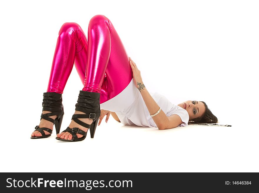 Young fashion model with pink shimery pants over white background. Isolated studio shot. Young fashion model with pink shimery pants over white background. Isolated studio shot.