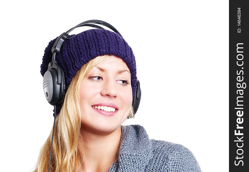 Smiling blond woman with headphones listening music over white