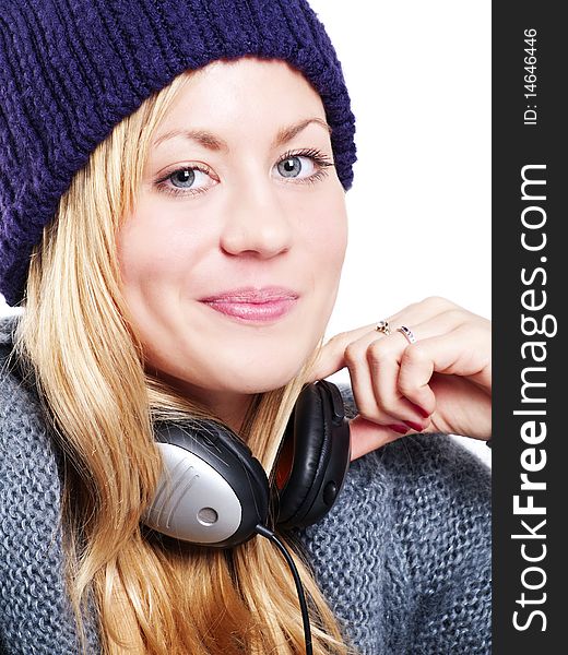 Closeup of smiling beautiful teenager with headphones listening music