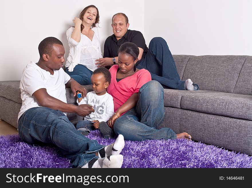 Young group of multiracial friends - two young families enjoying. Young group of multiracial friends - two young families enjoying