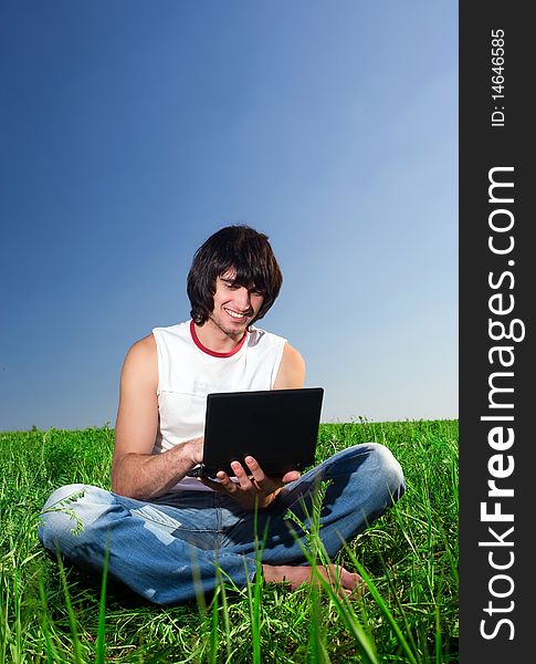 Boy with notebook on green grass