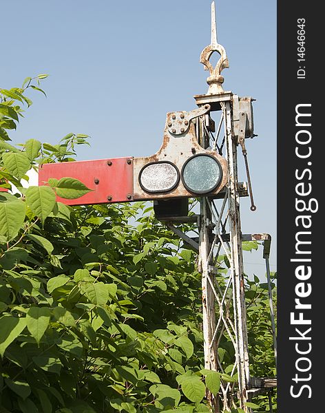 Old railway signal in overgrown area