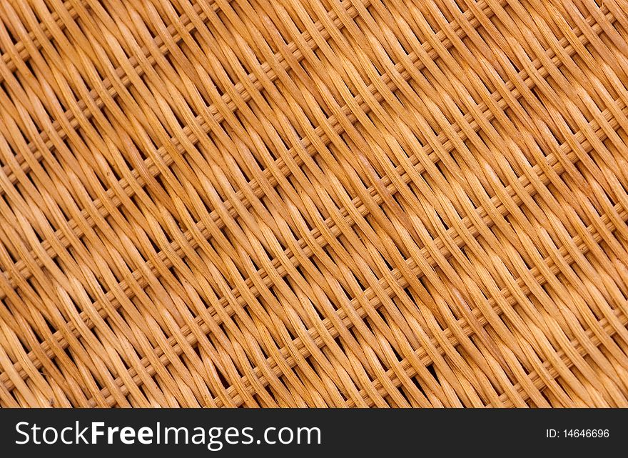 A close-up of a cane chair showing the texture and the pattern in a diagonal composition. A close-up of a cane chair showing the texture and the pattern in a diagonal composition