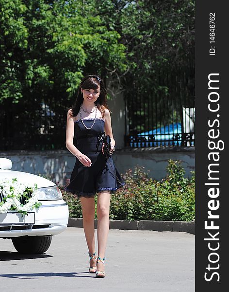 The young woman poses in the park in the summer