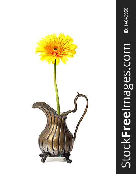Ancient brass ewer with flower  on white background