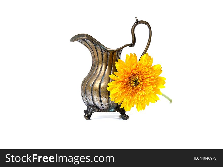 Ancient brass ewer with flower  on white background