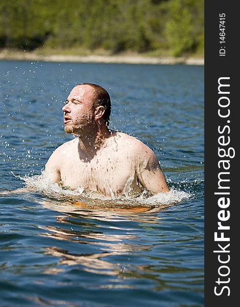 Man submerging after taking a dive in the water. Man submerging after taking a dive in the water