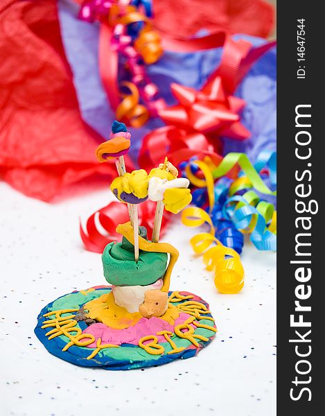 Child's self-made toy birthday cake with candles