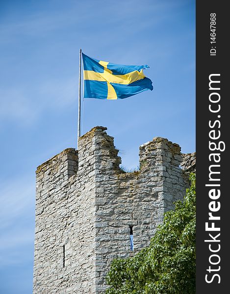 Swedish flag above medieval wall on Gotland