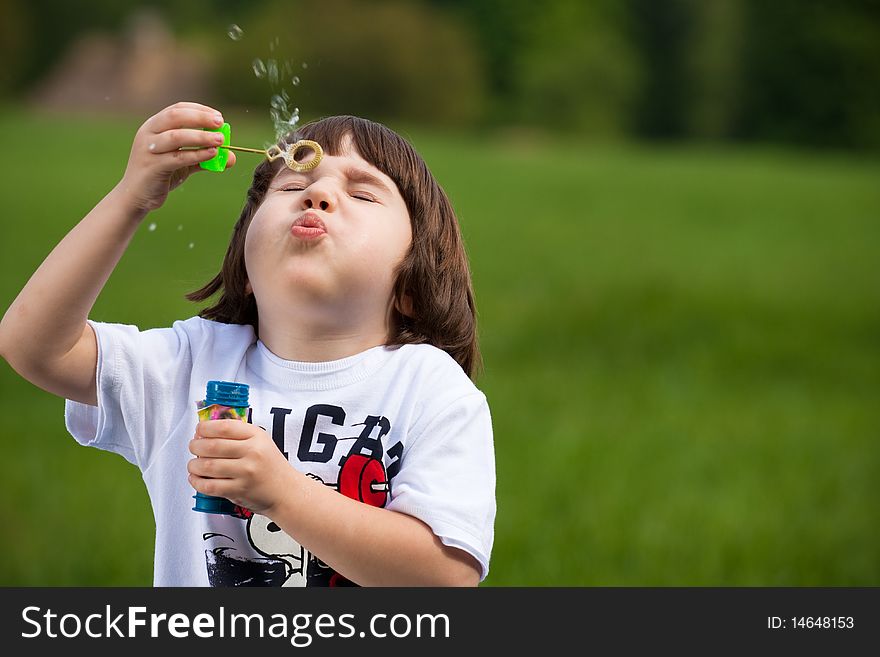 Boy tries to make a soap bubble. Boy tries to make a soap bubble