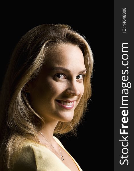 Portrait of an attractive young woman smiling towards the camera.  Vertical shot. Portrait of an attractive young woman smiling towards the camera.  Vertical shot.