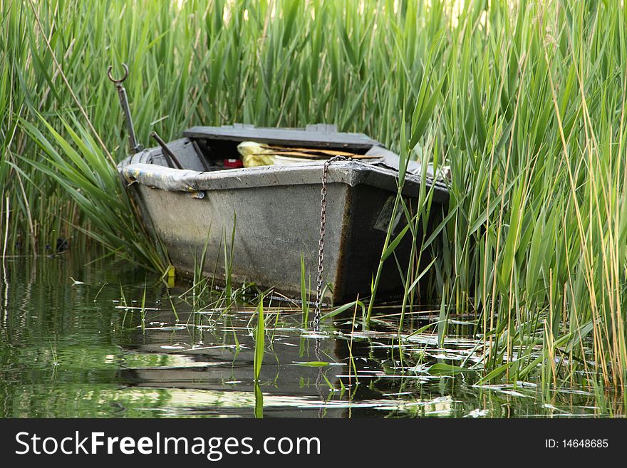 Old gray fishing ship in the varese lake. Old gray fishing ship in the varese lake