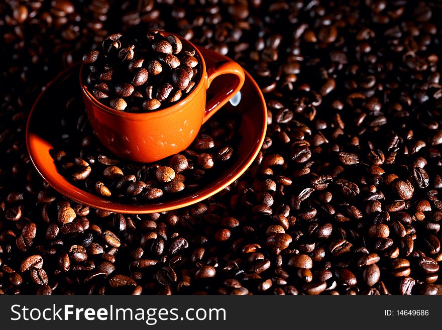 Full coffee cup with beans