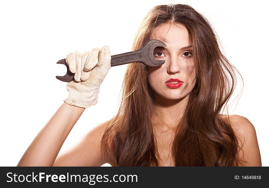 Young beautiful naked woman with wrench at white background. Young beautiful naked woman with wrench at white background