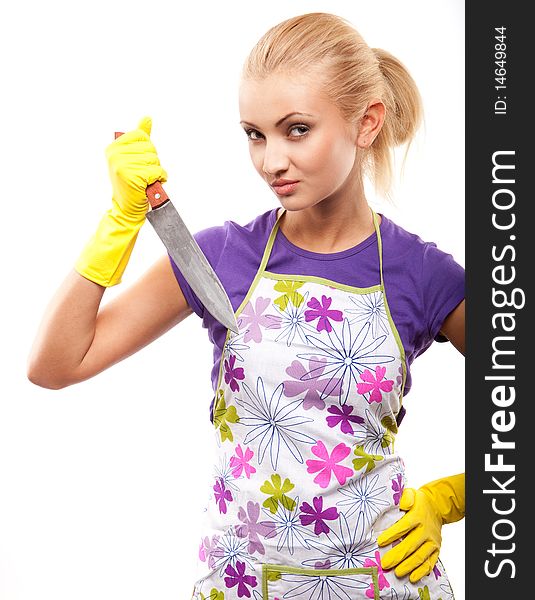 Young beautiful housewife in rubber yellow gloves with knife. Young beautiful housewife in rubber yellow gloves with knife