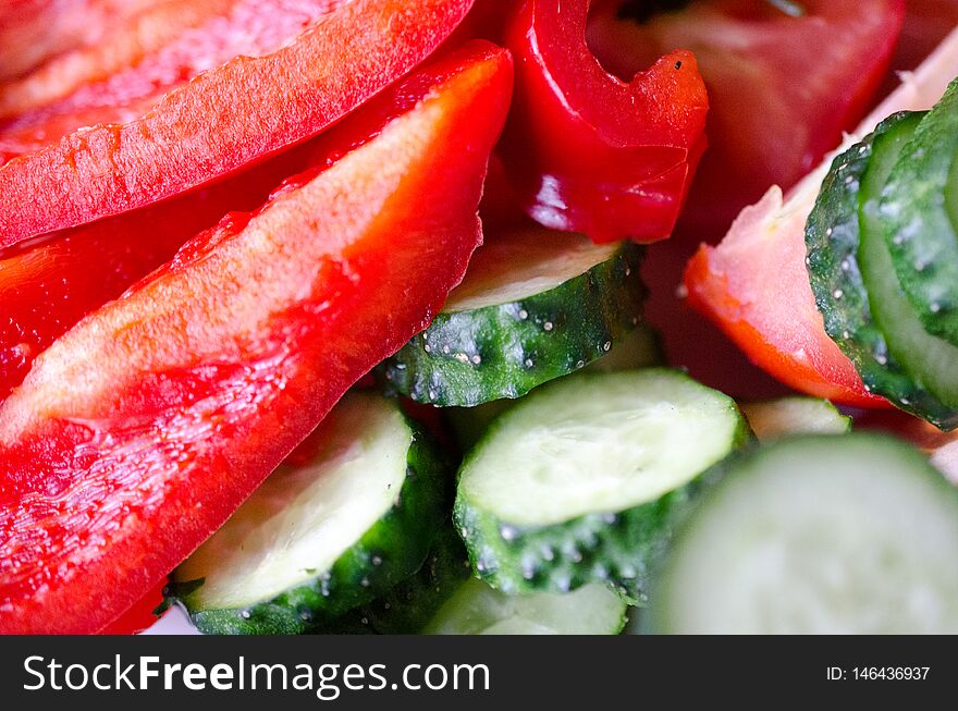 Fresh red pepper and green cucumber closeup