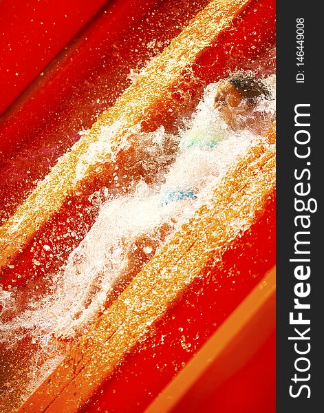 Little Caucasian Girl Inside Water Splash On Waterslide Of Water Park. Summer