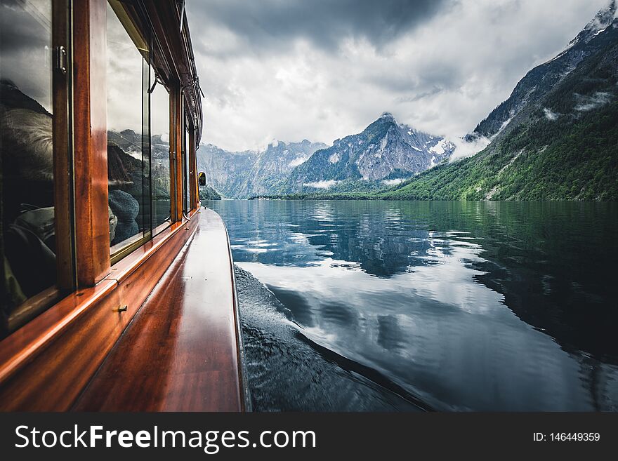 Traditional boat on famous Lake Konigssee on a beautiful modoy cloudy day in summer, Berchtesgadener Land, Bavaria, Germany. Traditional boat on famous Lake Konigssee on a beautiful modoy cloudy day in summer, Berchtesgadener Land, Bavaria, Germany