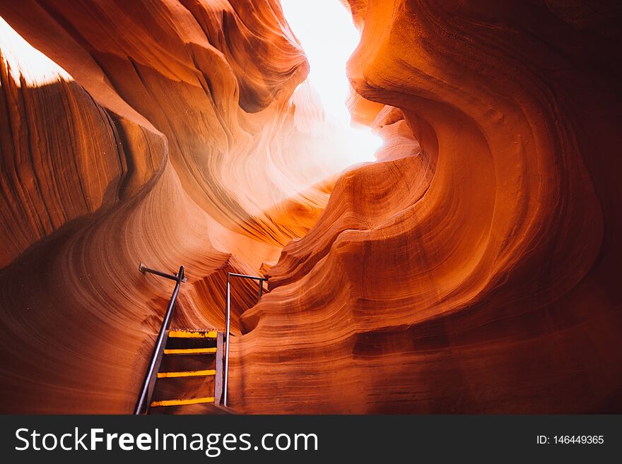 Beautiful view of amazing sandstone formations with a ladder leading toward a magic light beam in famous Antelope Canyon near the historic town of Page at Lake Powell, American Southwest, Arizona, USA. Beautiful view of amazing sandstone formations with a ladder leading toward a magic light beam in famous Antelope Canyon near the historic town of Page at Lake Powell, American Southwest, Arizona, USA