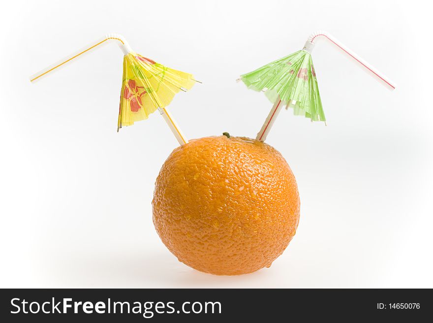 Orange with two straws and umbrellas isolated on white background