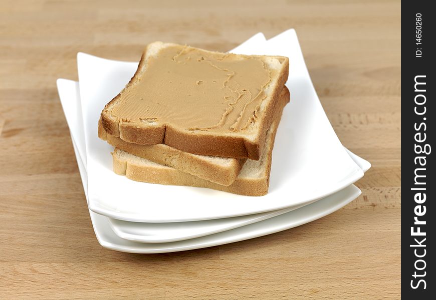 A slice of white bread with peanut butter