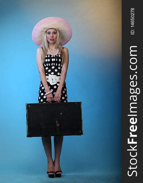 Studio shot of girl in sundress and in a hat. Studio shot of girl in sundress and in a hat