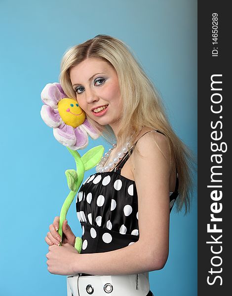 Girl with a toy flower. Studio shot