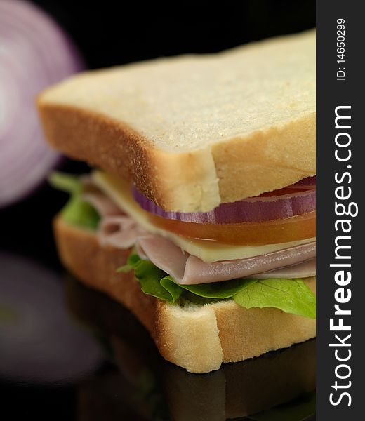 A freshly made ham sandwich on a kitchen bench