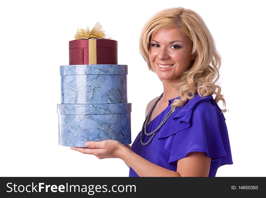 Beautiful smiling woman with a gift. Girl in purple dress is standing and holding purple box with gold ribbon on white background. Beautiful smiling woman with a gift. Girl in purple dress is standing and holding purple box with gold ribbon on white background.