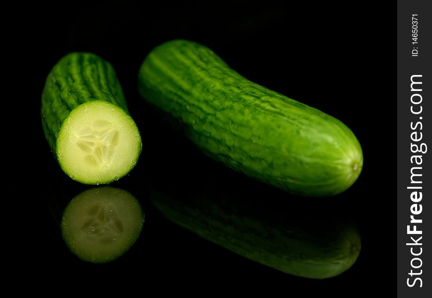 Lebanese cucumbers isolated against a black bacground